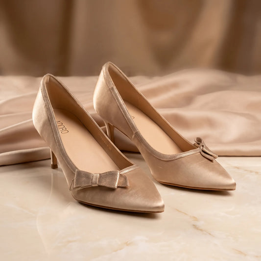Pointed-toe court shoes with a folded front bow, decorative trim and slim heel.