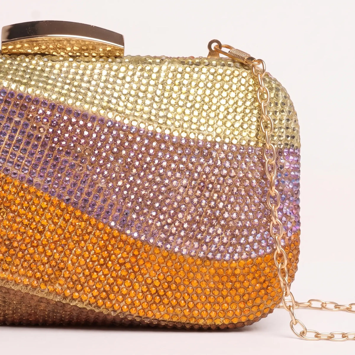 Rectangular clutch with wavy embellished bands, rounded corners and a curved clasp.