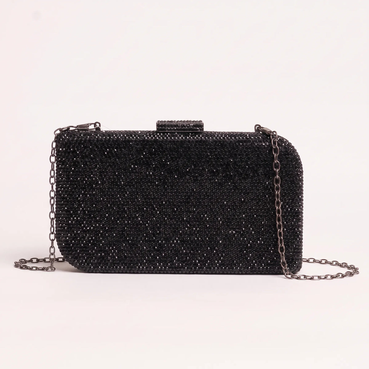Rectangular clutch with dense faceted embellishments, rounded corners and a top clasp.